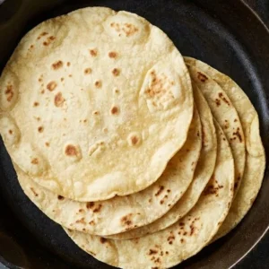 Freshly made authentic corn tortillas on a wooden board