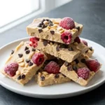 Frozen peanut butter yogurt bark topped with fruits and nuts