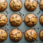 Healthy peanut butter banana muffins baked golden brown in a muffin tin