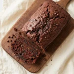 Delicious one-bowl chocolate zucchini bread topped with mini chocolate chips.