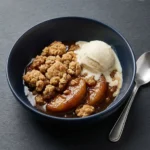 Healthy breakfast apple crumble topped with oats and nuts