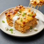 Cheesy Buffalo Ranch Chicken Lasagna topped with a creamy sauce and baked to perfection
